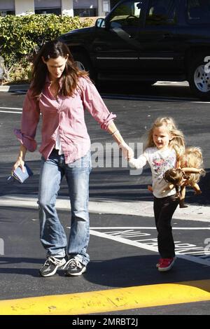 Jennifer Garner, maman qui se déporte, passe la journée avec sa fille Violet en remorquage. Le Garner vêtu de façon décontractée tient la main de Violet comme le jeune porte certaines de ses poupées comme compagnie. Los Angeles, Californie. 11/15/09. Banque D'Images