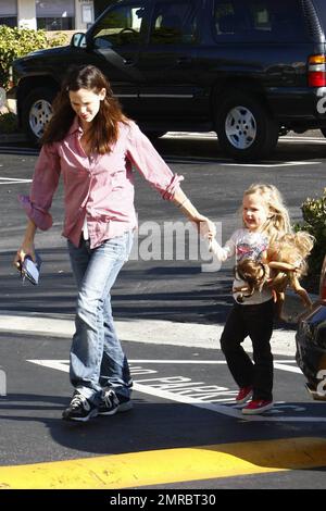 Jennifer Garner, maman qui se déporte, passe la journée avec sa fille Violet en remorquage. Le Garner vêtu de façon décontractée tient la main de Violet comme le jeune porte certaines de ses poupées comme compagnie. Los Angeles, Californie. 11/15/09. Banque D'Images