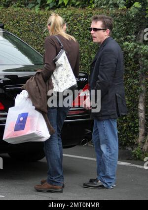 Exclusive!! Michael J Fox and wife Tracy Pollan shop at Fred Segal in Los Angeles, Ca. Fox, who is suffering from Parkinson's Disease, had noticeable tremors and kept his shaking hands in his pockets most of the time. 5/3/06 Stock Photo