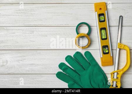 Composition de la couche plate avec les outils de menuisier sur fond blanc en bois. Espace pour le texte Banque D'Images