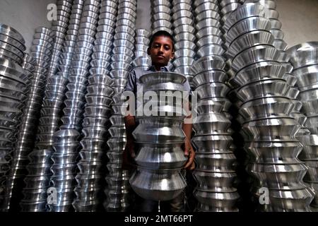 Dhaka, Dhaka, Bangladesh. 1st févr. 2023. Un enfant transporte des pots dans une usine de fabrication de pots en aluminium à Dhaka, au Bangladesh. Chacun des enfants gagne environ 80 GBP par mois travaillant plus de 12 heures par jour. De nombreux jeunes travailleurs migrent vers la ville de Dhaka pour de meilleurs emplois et vivent dans des bidonvilles. Il y a environ 1,7 millions de travailleurs de l'enfance dans le pays, dont 1,2 millions sont engagés dans des travaux dangereux. Selon la législation du travail au Bangladesh, l'âge minimum d'admission à l'emploi est de 14 ans. L'application d'une telle loi du travail est pratiquement impossible dans le pays parce que la plupart des enfants travailleurs sont employés Banque D'Images