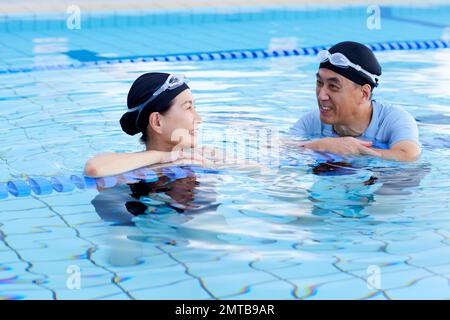 Couple senior japonais à la piscine intérieure Banque D'Images