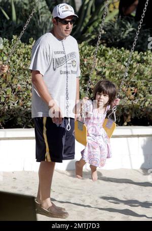 L'acteur Adam Sandler et la famille passent ensemble les vacances de la fête du travail à Malibu Country Mart. Pendant la journée, Sandler a pris le temps de pousser sa fille plus jeune Sunny sur le balançoire. Malibu, Californie 5th septembre 2011. . . Banque D'Images