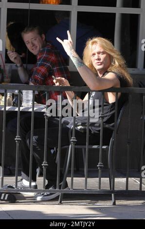 EXCLUSIF !! Canadien rocker et ancien leader du groupe Skid Row, Sebastian Bach fait clignoter les cornes du diable comme s'il était bon de dire bonjour aux paparazzi tout en dégustant un déjeuner dans un café extérieur. Los Angeles, Californie. 01/27/11. Banque D'Images