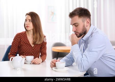 Couple avec des problèmes de relation à la table dans le café Banque D'Images