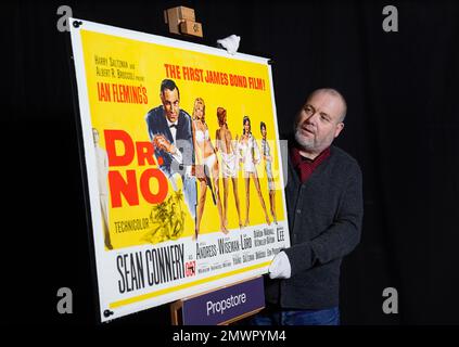 Mark Hochman, consultant en posters Propstore, regarde une affiche britannique pour le film de James Bond de 1962, 'DR Non' (estimation £10 000 - 20 000 £) lors d'un avant-goût de la vente aux enchères de souvenirs showbiz, au Propstore de Rickmansworth, Hertfordshire. Date de la photo: Jeudi 19 janvier 2023. Banque D'Images