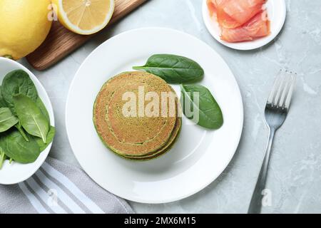 De savoureuses crêpes aux épinards servies sur une table en marbre gris clair, sur un plat Banque D'Images