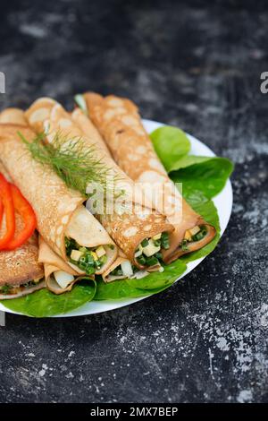 Délicieuses crêpes rudes avec oignons verts frais et œufs sur fond métallique Banque D'Images