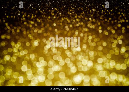 Fond doré brillant. Texture scintillante avec le bokeh et les lumières, feuille d'or en métal brillant Banque D'Images