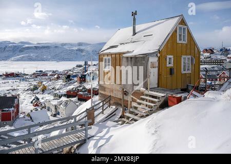 Maisons colorées accrochant sur le flanc de la montagne à Uummannaq dans l'ouest du Groenland Banque D'Images