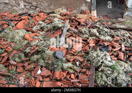 Une pile de tuiles de toit brisées d'un bâtiment démoli. Banque D'Images