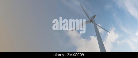 parc éolien ou ferme de moulin à vent de bannière floue, avec des éoliennes à fort vent pour la production d'électricité. Concept de production d'énergie verte. Les développeurs durables Banque D'Images