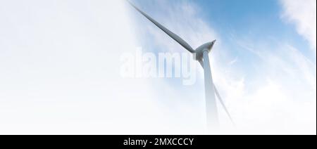 parc éolien ou ferme de moulin à vent de bannière floue, avec des éoliennes à fort vent pour la production d'électricité. Concept de production d'énergie verte. Les développeurs durables Banque D'Images