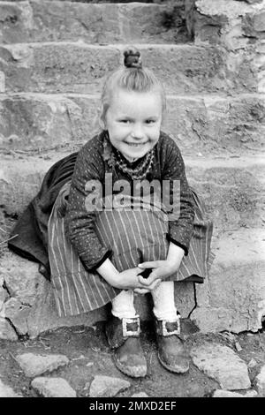 Porträt eines Mädchens in der Tracht des Schwalm-Eder-Kreises in Hessen, Deutschland, 1938. Portrait d'une fille portant la robe traditionnelle de la région de Schwalm-Eder à Hesse, Allemagne, 1938. Banque D'Images