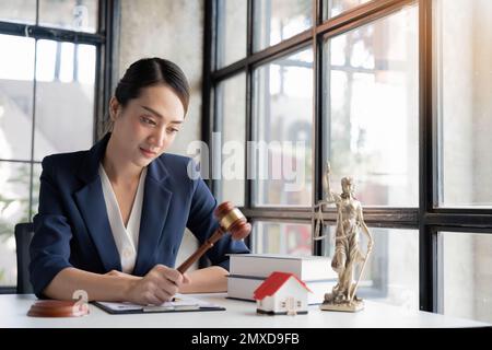 Image sélective, Une femme avocate asiatique professionnelle millénaires, PR avocat tenant un juge gavel ou juge marteau à son bureau Banque D'Images