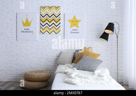 Intérieur de la chambre d'enfant avec lit et jolies affiches sur le mur Banque D'Images