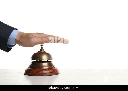 Un homme sonnant la cloche de service de l'hôtel à une table en bois Banque D'Images