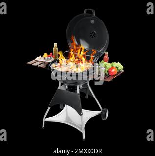 Barbecue moderne flamboyant avec des plats savoureux sur fond noir Banque D'Images