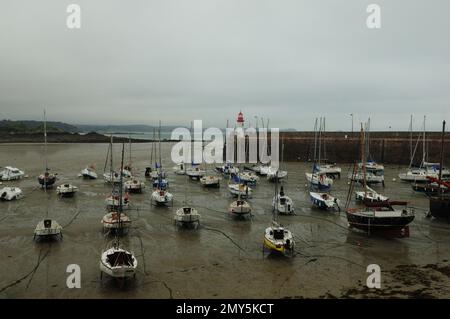 Les bateaux s'agronnent pendant la marée basse dans le port d'Erquy en Bretagne France lors d'une journée d'été Banque D'Images