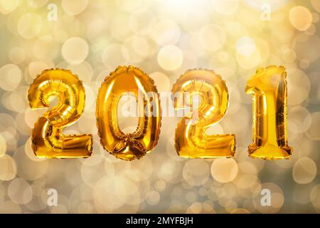 Célébration du nouvel an 2021. Ballons or lumineux et lumières floues en arrière-plan Banque D'Images