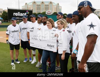 IMAGE DISTRIBUTED FOR RELIANT, AN NRG COMPANY - Dallas Cowboys rookie  running back Darius Jackson autographs a fan's shirt during the Reliant  Home Run Derby at the Dr Pepper Ballpark on Tuesday