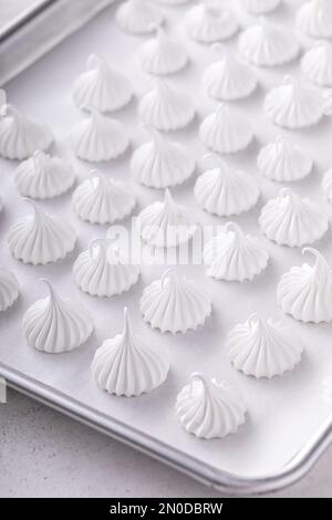 Meringue embrasse sur une plaque de cuisson prête à être cuite, idée de biscuits faits maison Banque D'Images