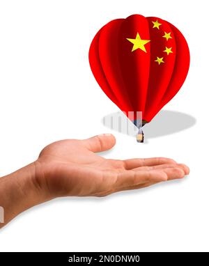 Le ballon de la Chine sur la main de l'Amérique. Banque D'Images