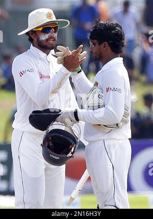 Sri Lankan cricketers Dinesh Chandimal, left, and Kusal Janith Perera celebrate their team's victory over West Indies in the first test cricket match in Galle, Sri Lanka, Saturday, Oct. 17, 2015. Sri Lanka beat West Indies by an innings and 6 runs in the first test cricket match. ( AP Photo/ Pamod Nilru )