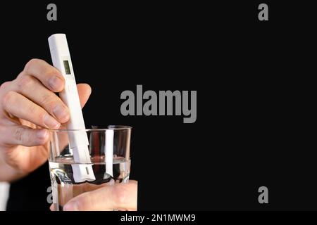 Testeur de qualité de l'eau dans un verre d'eau. Mesure de la qualité de l'eau potable. Banque D'Images