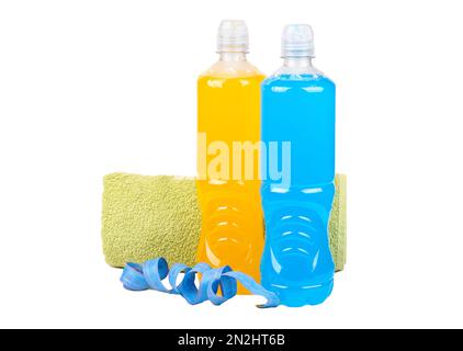 Bouteilles avec boissons isotoniques bleues et orange dans une serviette et ruban centimètre sur fond blanc. Le concept de courir et de perdre du poids. Banque D'Images