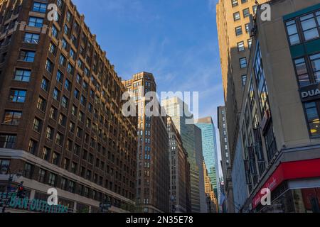 Vue magnifique sur les sommets des gratte-ciels de Manhattan sur fond bleu ciel. New York, États-Unis. Banque D'Images