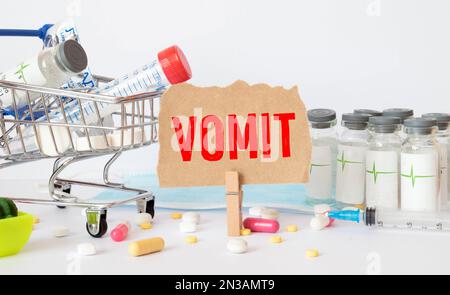 vomit mot écrit sur bloc de bois. vomit texte sur table en bois pour votre desing, concept de coronavirus vue de dessus. Banque D'Images