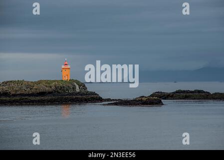 Phare de Klofningur sur la petite île de Klofningur au large de l'île de Flatey, partie d'un groupe d'environ quarante grandes et petites îles et... Banque D'Images