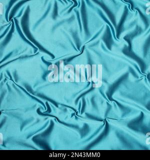 Arrière-plan abstrait, texture de la soie bleu-vert émiettée. Banque D'Images