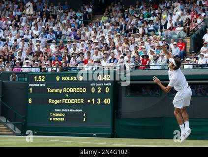 Roger Federer of Switzerland serves to Tommy Robredo of Spain during their men’s singles match at the All England Lawn Tennis Championships in Wimbledon, London, Tuesday July 1, 2014. (AP Photo/Pavel Golovkin)