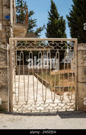 Bethléem, Cisjordanie, Palestine - 22 juillet 2022 : porte blanche d'une maison aux arbres en arrière-plan Banque D'Images