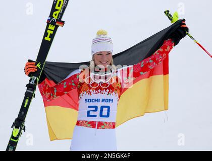 Germany's Maria Hoefl-Riesch poses with the national flag as she celebrates winning the gold medal in the women's supercombined at the Sochi 2014 Winter Olympics, Monday, Feb. 10, 2014, in Krasnaya Polyana, Russia. (AP Photo/Gero Breloer)