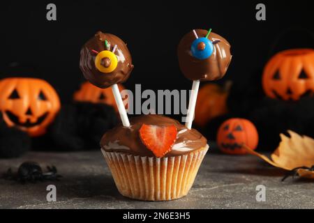 Délicieux desserts décorés comme des monstres sur une table grise. Halloween Banque D'Images