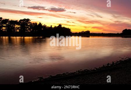 Coucher de soleil sur Hatchet Pond, New Forest, Hampshire (sur la route Beaulieu à Lymington). Banque D'Images