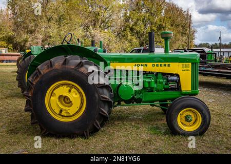 Fort Meade, FL - 22 février 2022: Vue latérale en haute perspective d'un tracteur spécial riz John Deere 830 1959 lors d'un salon de voiture local. Banque D'Images