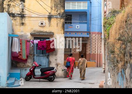 DIU, Inde - décembre 2018 : vue arrière de deux femmes marchant dans une ruelle étroite dans un vieux quartier de la ville de DIU. Banque D'Images