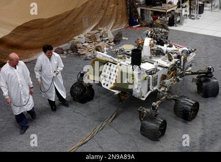 FILE - In this file photo taken Thursday, Aug. 2, 2012, engineers work on a model of the Mars rover Curiosity at the Spacecraft Assembly Facility at NASA's Jet Propulsion Laboratory in Pasadena, Calif., After traveling 8 1/2 months and 352 million miles, Curiosity will attempt a landing on Mars the night of Aug. 5, 2012. (AP Photo/Damian Dovarganes, File)
