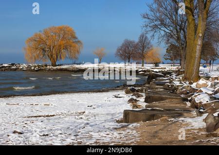 La lumière du soleil se dégage après une tempête hivernale qui déverse de la neige le long des rives du lac Érié, à Edgewater Park, à Cleveland, Ohio. Banque D'Images