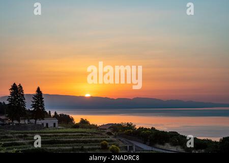 Lever de soleil sur la mer Ionienne et les montagnes de Calabre sur le continent de l'Italie, vue de la côte est de la Sicile Banque D'Images