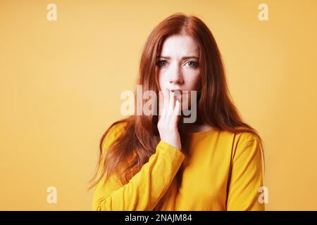 inquiète effrayée jeune femme couvrant sa bouche avec sa main - notion d'anxiété Banque D'Images