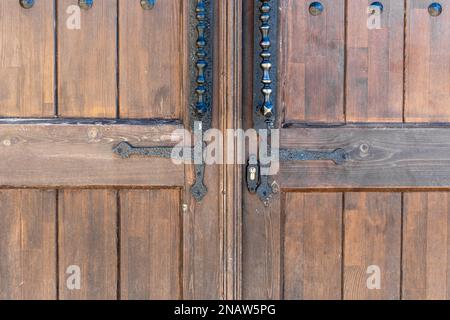 Ancienne porte en bois classique, marron, avec poignée en fer. Textures et arrière-plan de la porte. Photo de haute qualité Banque D'Images