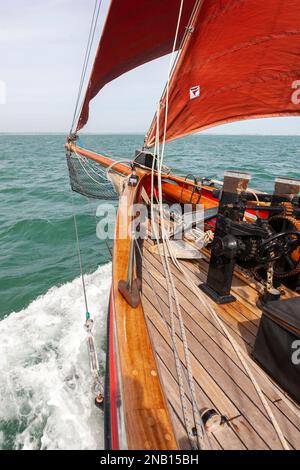 À bord de la découpeuse traditionnelle Jolie brise, qui traverse Solent, Hampshire, Royaume-Uni, et crée une fine vague d'arc Banque D'Images