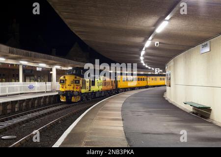 Colas Rail Freight classe 37 locomotive diesel à Carnforth avec le train de surveillance de l'infrastructure de reconnaissance de la ligne simple de réseau ferroviaire Banque D'Images