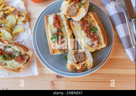 Sandwiches ou sandwiches italiens Meatball avec fromage et frites maison sur une table de dîner. Pose à plat Banque D'Images