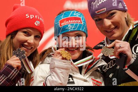 Elisabeth Goergl, of Austria, center, winner of the women's super-G race, poses on the podium with silver medal winner Julia Mancuso, of the United States, left, and bronze medal's winner Maria Riesch, of Germany, at the Alpine World Skiing Championships in Garmisch-Partenkirchen, Germany, Tuesday, Feb. 8, 2011. (AP Photo/Matthias Schrader)